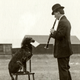 Musician Fred Campbell is helped out by his dog Shine, circa 1960.